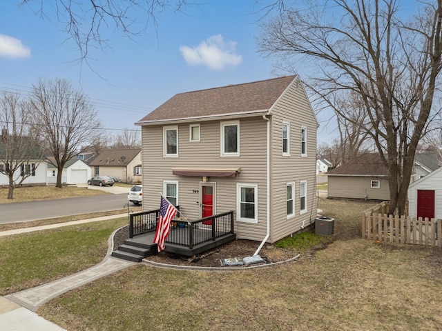 949 9th Ave SE, Rochester, MN 55904 - view of front of property with roof with shingles, a front yard, central AC unit, a wooden deck, and fence