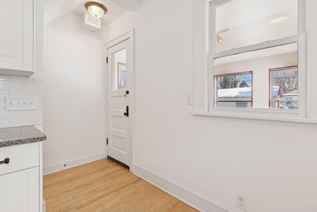 interior space with light wood finished floors and baseboards