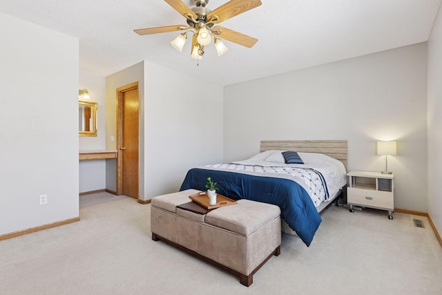 carpeted bedroom featuring visible vents, baseboards, and ceiling fan