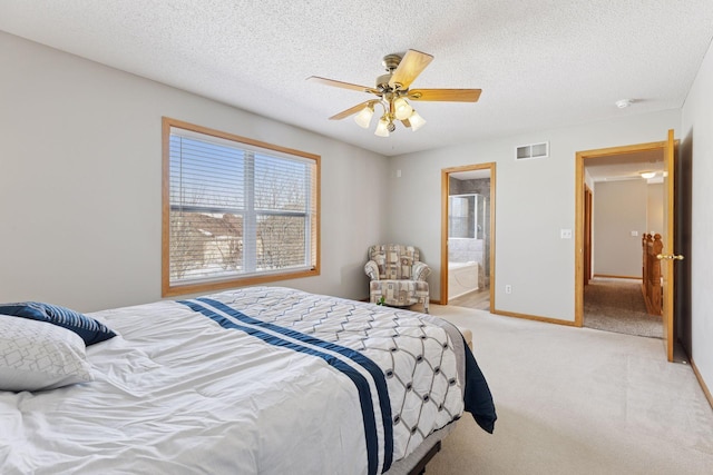 carpeted bedroom with a ceiling fan, baseboards, visible vents, ensuite bath, and a textured ceiling