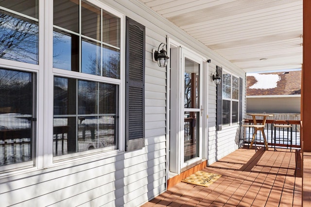 wooden terrace featuring covered porch