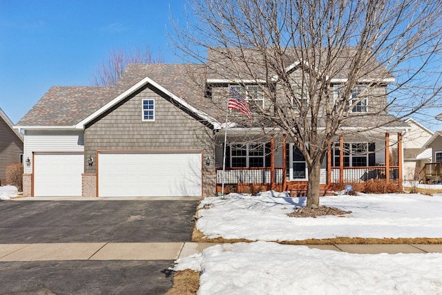 view of front of house with aphalt driveway, a porch, and brick siding