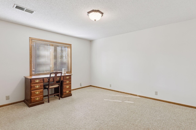 office area with light colored carpet, visible vents, a textured ceiling, and baseboards