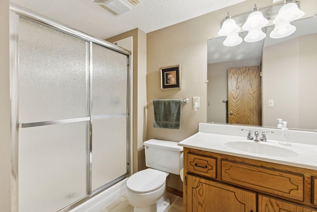 bathroom with toilet, vanity, a shower stall, and visible vents