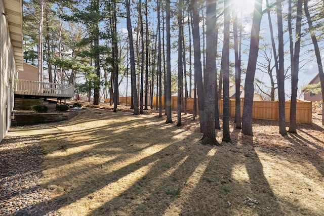 view of yard featuring fence and a wooden deck