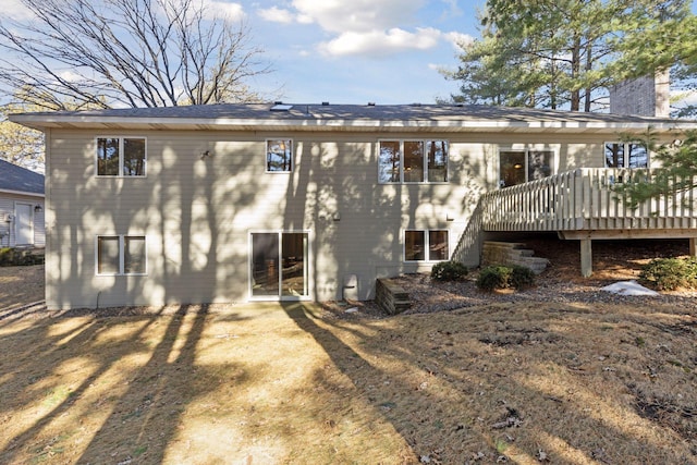 rear view of house featuring a chimney and a wooden deck