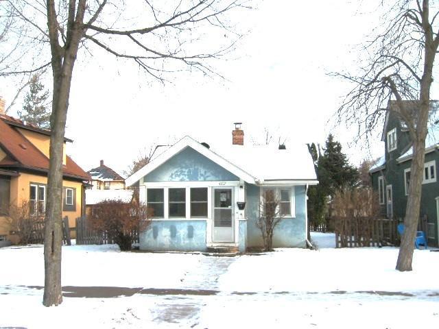 bungalow with a chimney and fence