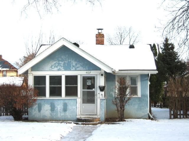 view of front of property with entry steps, a chimney, and stucco siding