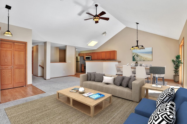 13413 Pine View Pl, Lindstrom, MN 55045 - living area featuring ceiling fan, vaulted ceiling, light colored carpet, and baseboards