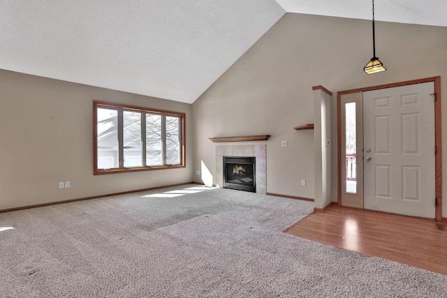 13413 Pine View Pl, Lindstrom, MN 55045 - unfurnished living room with carpet, high vaulted ceiling, a fireplace, and baseboards