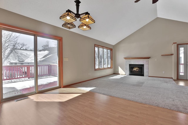 13413 Pine View Pl, Lindstrom, MN 55045 - unfurnished living room featuring a ceiling fan, plenty of natural light, a fireplace, baseboards, and high vaulted ceiling