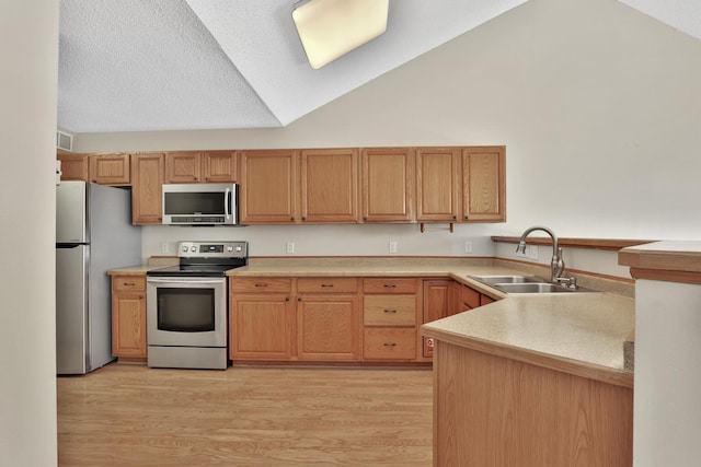 13413 Pine View Pl, Lindstrom, MN 55045 - kitchen featuring light wood finished floors, stainless steel appliances, a sink, and vaulted ceiling