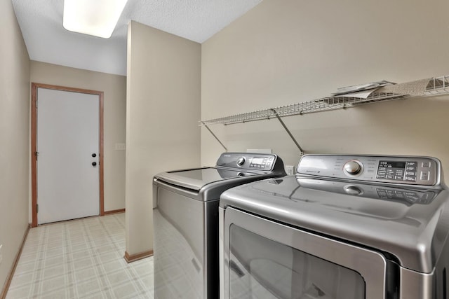 13413 Pine View Pl, Lindstrom, MN 55045 - laundry room with washer and clothes dryer, light floors, and baseboards