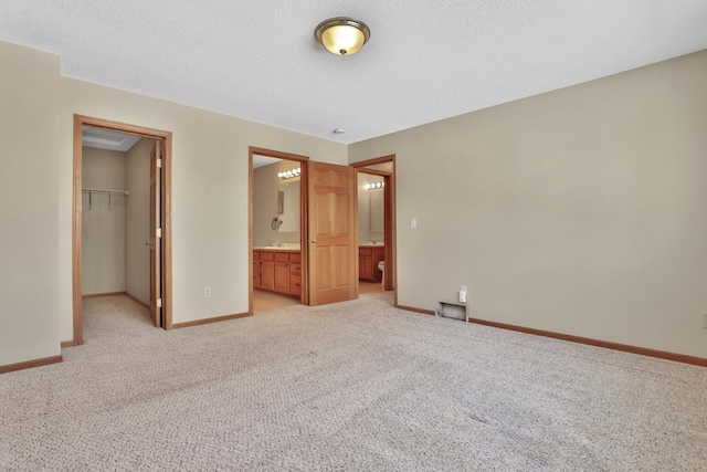 13413 Pine View Pl, Lindstrom, MN 55045 - unfurnished bedroom featuring a spacious closet, light carpet, baseboards, a closet, and ensuite bathroom