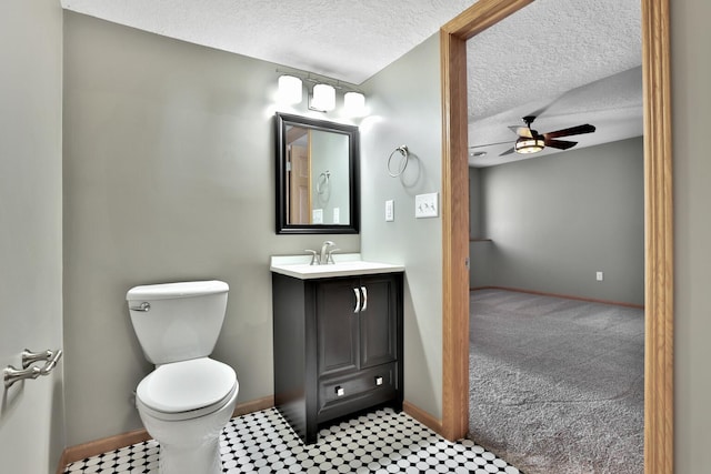 13413 Pine View Pl, Lindstrom, MN 55045 - bathroom with ceiling fan, baseboards, toilet, a textured ceiling, and vanity
