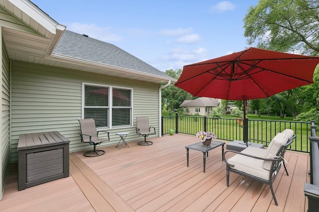 wooden terrace featuring a yard and an outdoor living space