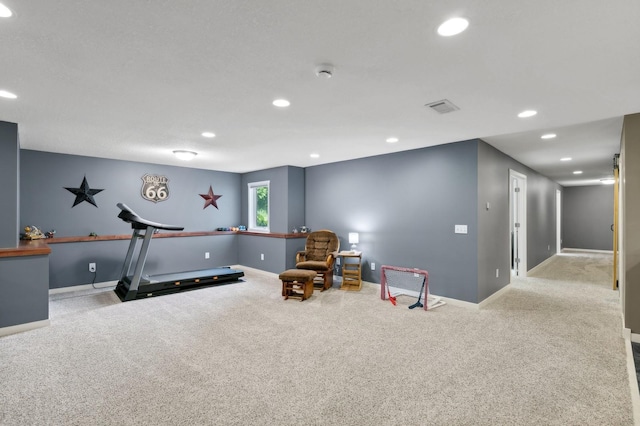 workout room featuring baseboards, recessed lighting, visible vents, and light colored carpet