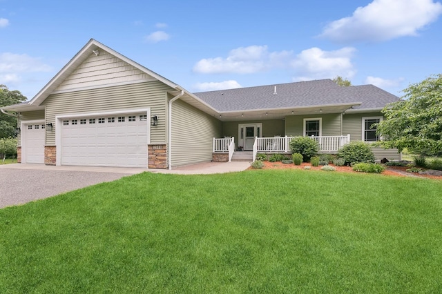 single story home featuring a garage, roof with shingles, a porch, and a front yard