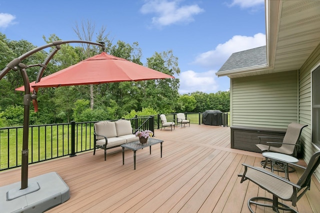 wooden deck with outdoor lounge area and a grill