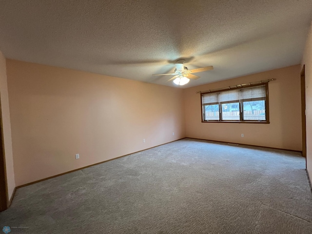 carpeted empty room featuring a ceiling fan, baseboards, and a textured ceiling