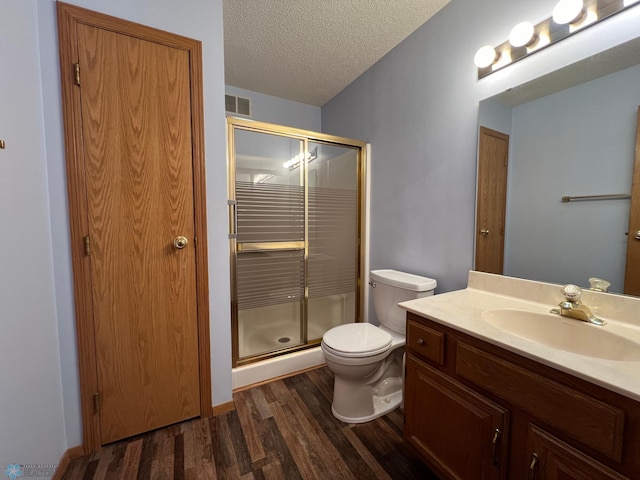 bathroom with visible vents, a stall shower, a textured ceiling, and wood finished floors