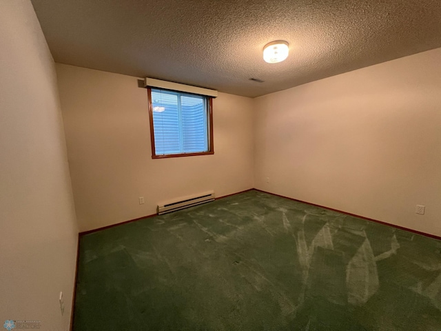 carpeted spare room with baseboards, baseboard heating, and a textured ceiling