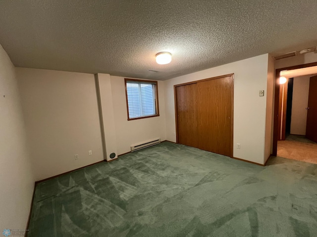 unfurnished bedroom with a baseboard heating unit, a textured ceiling, and carpet flooring