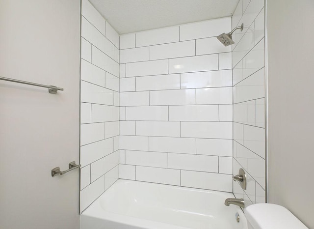 bathroom with bathing tub / shower combination and toilet