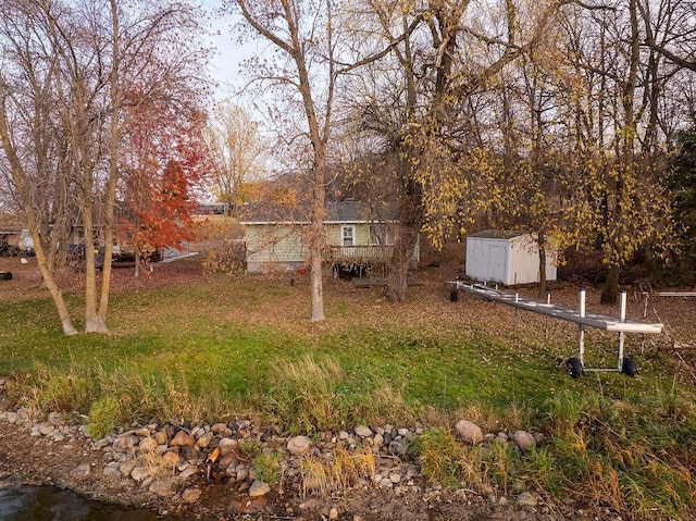 view of yard with a storage shed and an outdoor structure