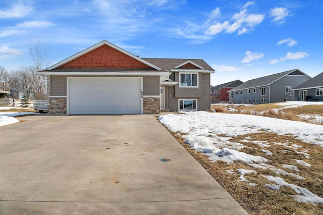 craftsman-style house featuring stone siding and concrete driveway