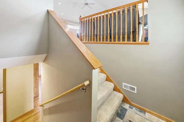 stairway featuring baseboards, wood finished floors, visible vents, and ceiling fan