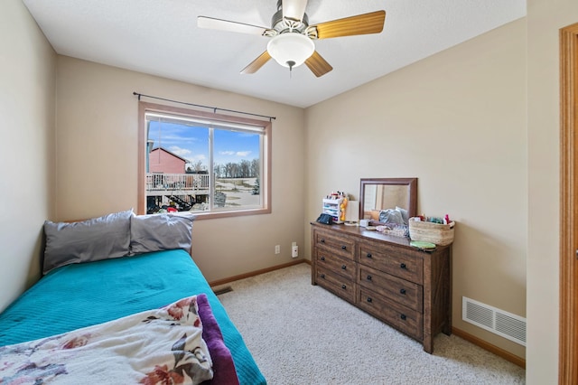 bedroom featuring visible vents, baseboards, carpet, and ceiling fan