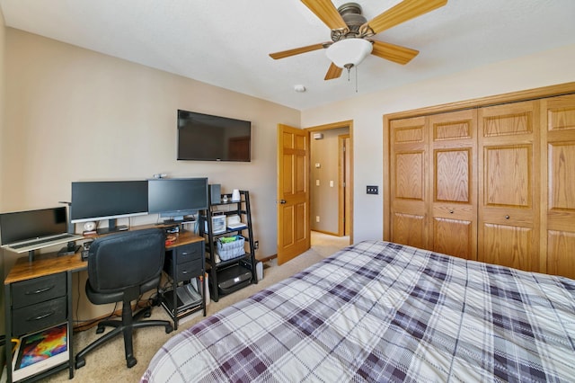 bedroom with a closet, light carpet, baseboards, and a ceiling fan