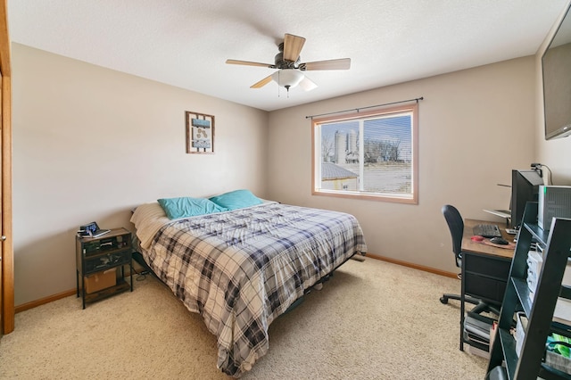 carpeted bedroom featuring ceiling fan and baseboards