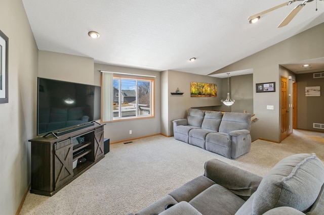 carpeted living room with visible vents, baseboards, and vaulted ceiling