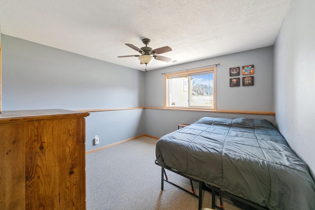 bedroom featuring carpet flooring, a ceiling fan, baseboards, and a textured ceiling