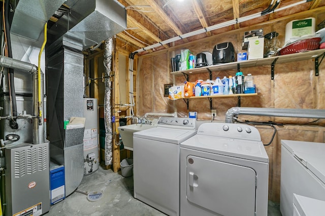 laundry room featuring heating unit, washing machine and clothes dryer, laundry area, water heater, and a sink