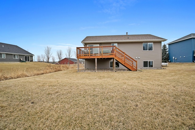 rear view of property with stairway, a yard, and a deck