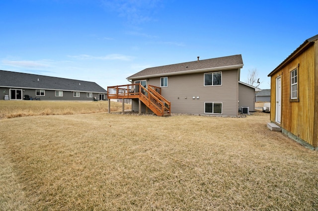 rear view of house featuring stairway, a yard, central AC unit, and a wooden deck