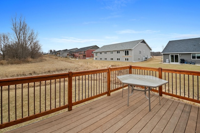 wooden deck with a lawn and a residential view