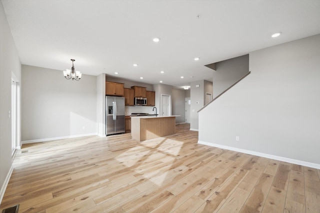 unfurnished living room with recessed lighting, baseboards, visible vents, and light wood finished floors