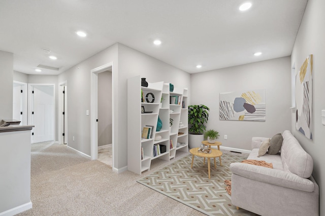 living area with recessed lighting, baseboards, and light colored carpet