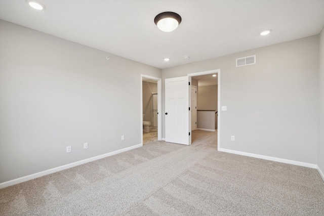 empty room with recessed lighting, baseboards, visible vents, and light colored carpet