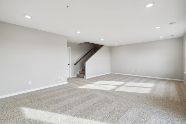 empty room featuring baseboards, stairs, visible vents, and recessed lighting