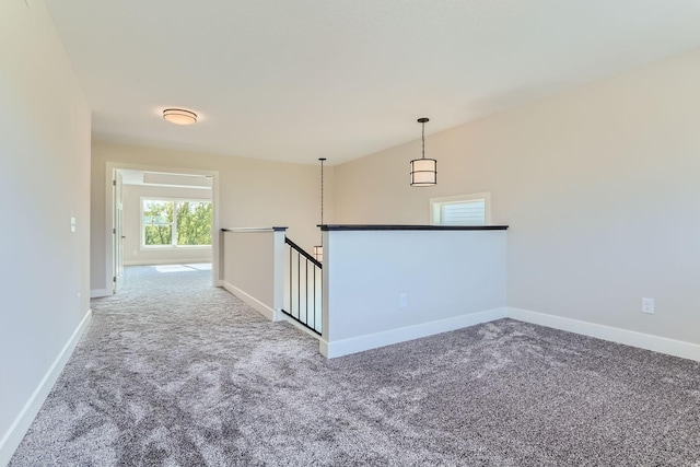 unfurnished room with carpet floors and baseboards