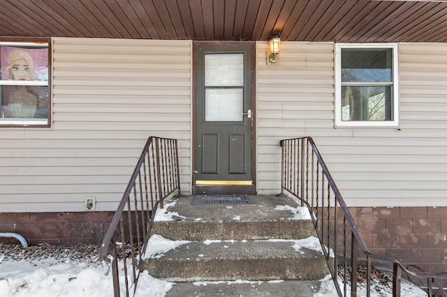 view of snow covered property entrance