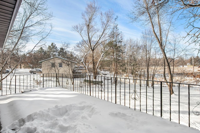 yard covered in snow with fence