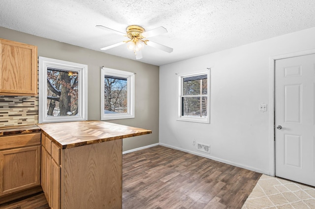 kitchen featuring tasteful backsplash, visible vents, wood counters, dark wood-style flooring, and a textured ceiling