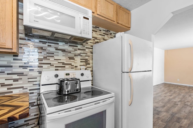 kitchen with wood finished floors, white appliances, backsplash, and baseboards