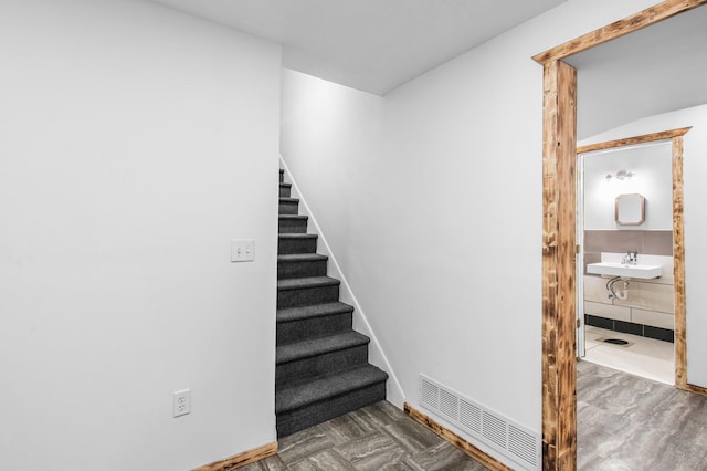 stairs with baseboards and visible vents